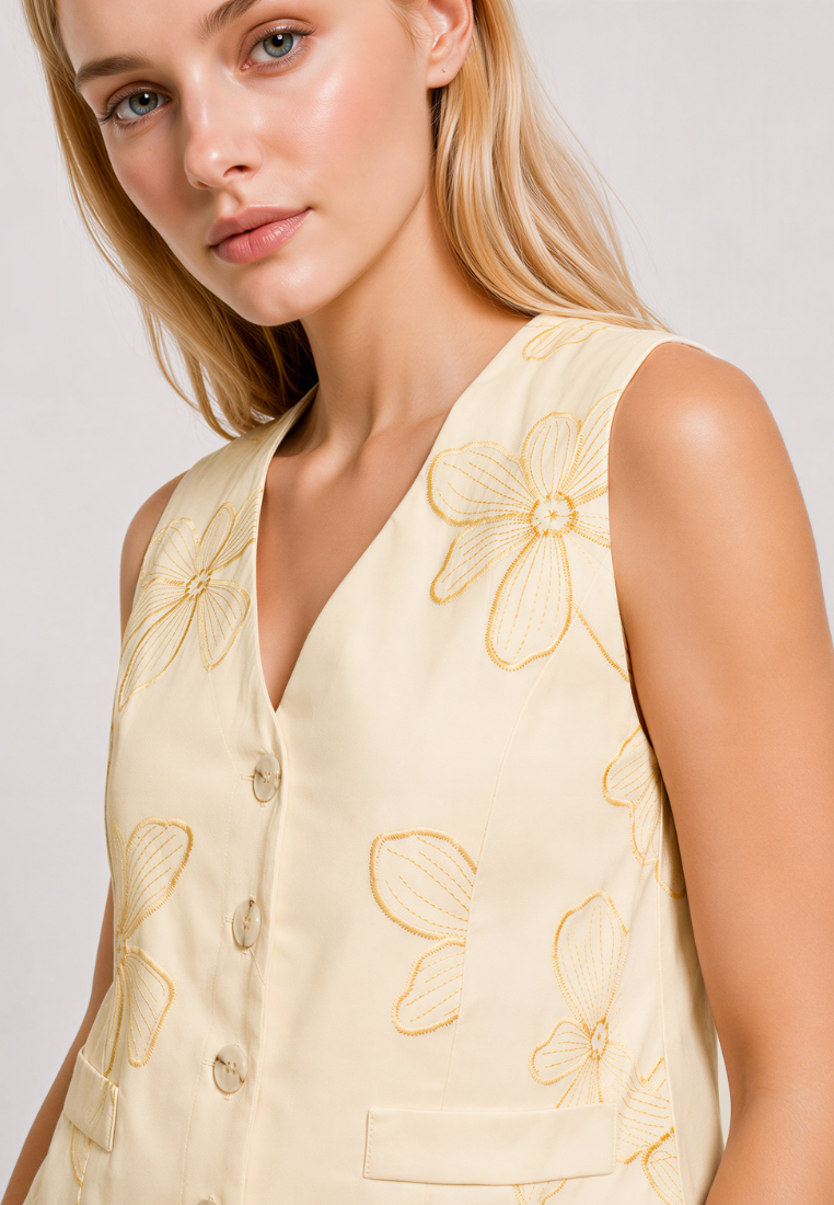 Close-up of Love Knot Lena vest top — floral embroidery and decorative flap pocket detail