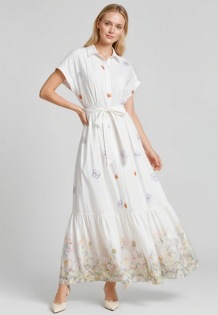 Woman wearing Love Knot Winnie white floral tiered maxi dress, front view with collar and tie waist sash