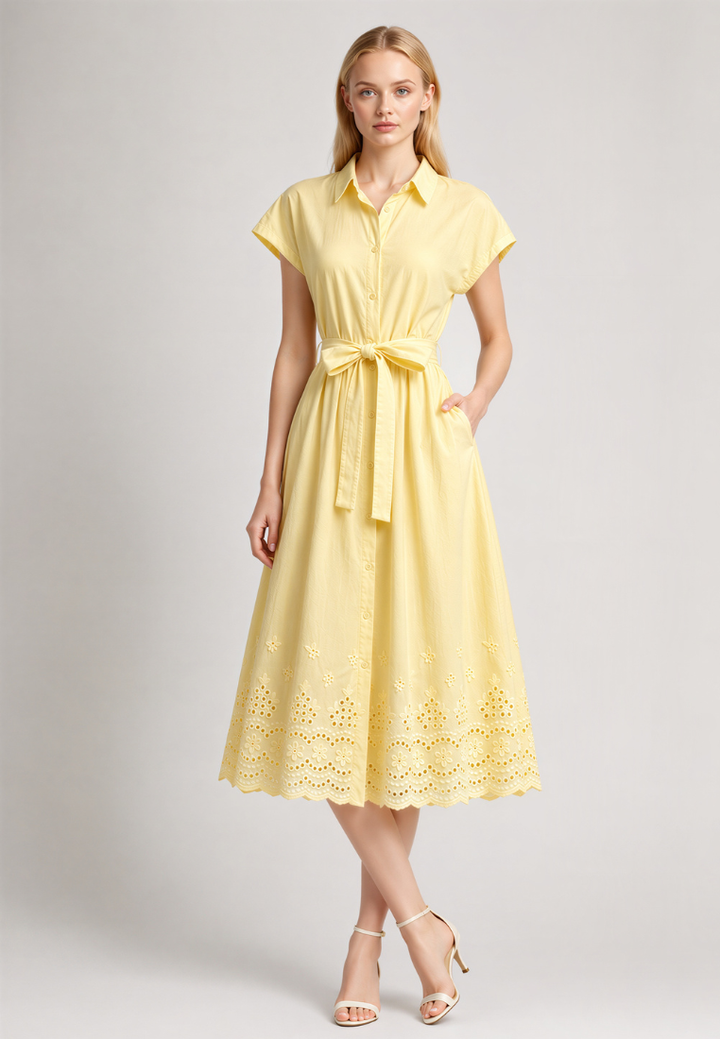 Woman wearing Love Knot Hazel yellow cotton eyelet shirt dress, front view with tie waist sash